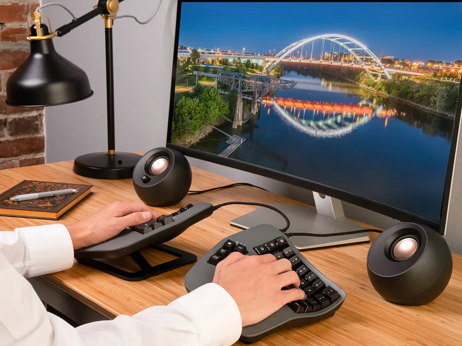 Kinesis Advantage2 single-unit contoured ergonomic keyboard beside the Kinesis Advantage360 Pro split wireless keyboard — side-by-side comparison for wrist pain, carpal tunnel, and RSI relief