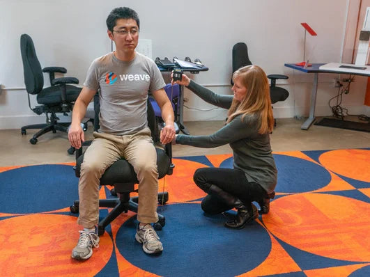 Ask Ergo Works certified ergonomic specialist performing a chair fitting assessment with a client at the Palo Alto showroom