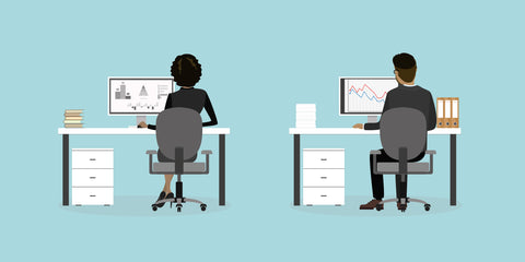 Two employees sitting at their desks in office chairs