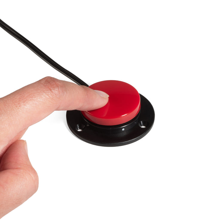 User pressing AbleNet Specs IC accessibility switch for assistive technology activation