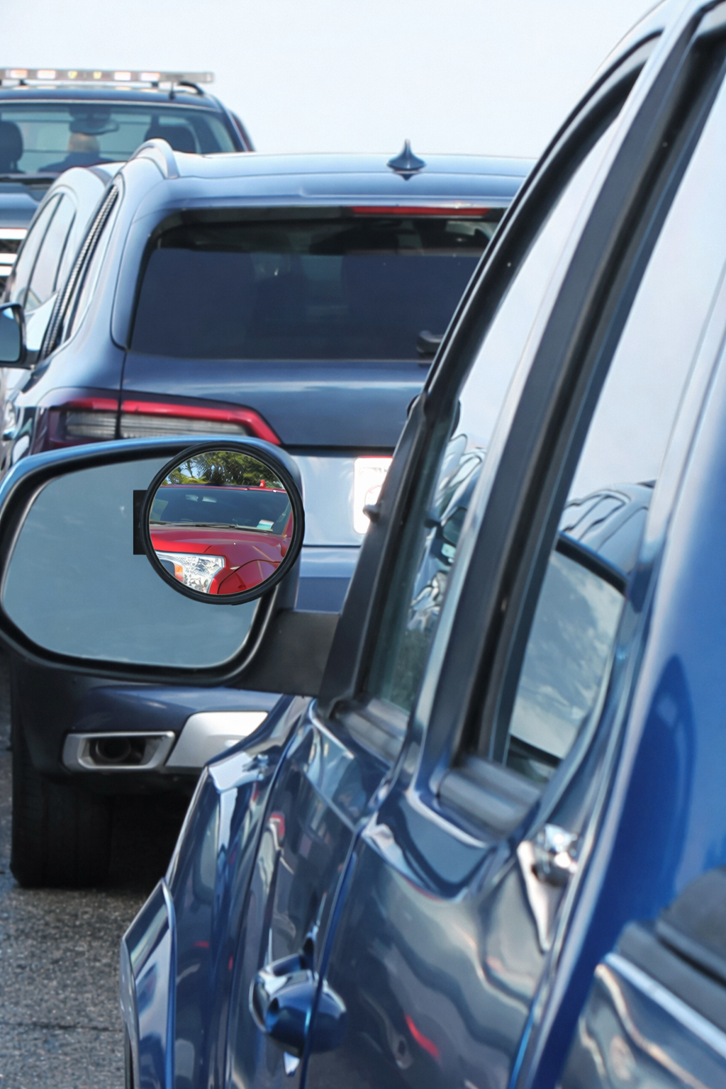 True View® Accurate Imaging Blind Spot Mirror (for trucks/SUVs/RVs) Close-up of a car's side mirror and blind spot mirror with another vehicle in the background.